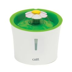 a green and white water fountain with a flower on it's top, sitting in front of a white background