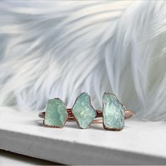 Raw aquamarine stones are electroformed with pure copper, creating a simple and dainty, every day style ring. Each ring is made by hand and electroformed for 12 hours, allowing a unique copper design to develop and encase the stone. Rings are then buffed, polished and sealed with a protective layer to maximize luster, keep the bright and clean rose gold tone, and prevent potential tarnishing and skin discoloration that can occur on some people who wear copper jewelry. Electroforming is a very ti Aquamarine Stone Ring, March Birthstone Ring, Raw Crystal Ring, Raw Aquamarine, Copper Design, March Birthstone Jewelry, Electroformed Jewelry, Sparkly Things, Ring Birthstone