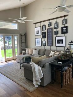 a living room filled with furniture and pictures on the wall