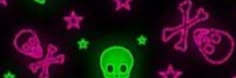 a green skull and crossbones glow in the dark, with pink stars around it