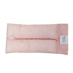 a pink pillow with stars on it and a white tag hanging from the back of it