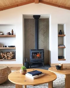 a living room filled with furniture and a fire place in the middle of it's walls