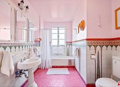 a bathroom with pink floors and white fixtures