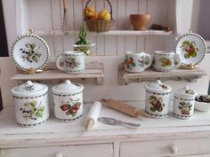 an old dresser with dishes and utensils on it