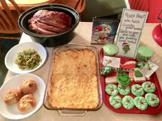 a table topped with lots of food and desserts