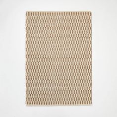 a brown and white square rug on a white wall with an abstract pattern in the middle