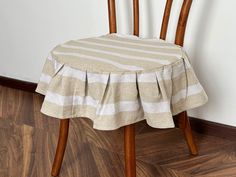 a wooden chair with a striped table cloth on it