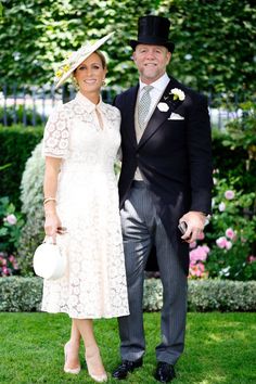 a man and woman standing next to each other on top of a lush green field