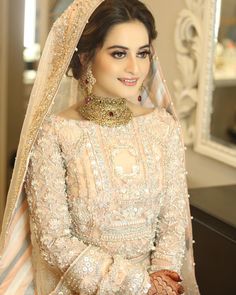 a woman in a bridal outfit looking at the camera