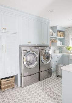 a washer and dryer in a white kitchen