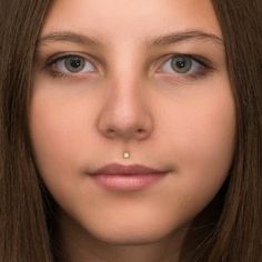 a close up of a person wearing a nose ring with a diamond in the middle