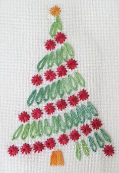 a cross stitch christmas tree with red flowers on it's bottom and green trim