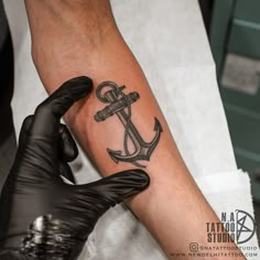 a man with a tattoo on his arm and an anchor tattooed on the arm,