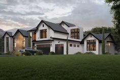 a large white house sitting on top of a lush green field