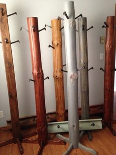 a bunch of wooden poles that are on the floor in front of a white wall