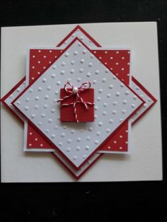 a red and white card with a bow on it