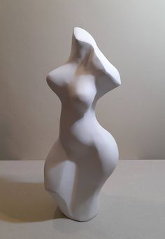 a white sculpture sitting on top of a table