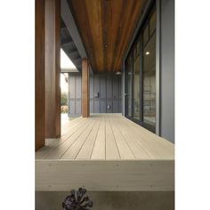 an empty wooden porch with glass doors