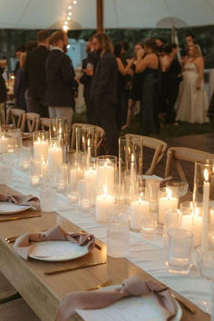 a long table is set with candles and place settings