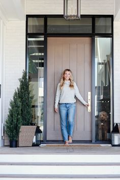 a woman standing in front of a door