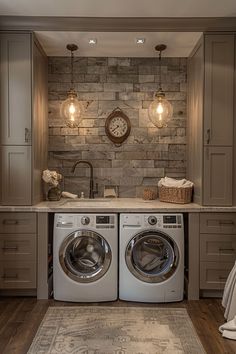 a washer and dryer in a very nice looking room with wood flooring