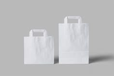 two white paper bags sitting on top of each other