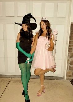 two women dressed in costumes posing for the camera