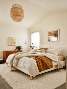 a bedroom with a bed, dresser and lamp in it's centerpieces