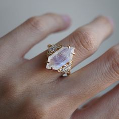 Inspired by the Art Deco period, our Frozen Moonstone Diamond Ring features a stunning elongated hexagon natural moonstone encrusted with natural white diamonds. It's like the moonlight stuck in a frozen iceberg. All Heirloom pieces come in a Tippy Taste ring box. This ring is handcrafted and designed in NYC. Available in 14K and 18K yellow gold, rose gold and white gold. 14K or 18K solid gold 1.5 mm band 17x7.5mm Natural long hexagon moonstone Natural round white diamonds. SI clarity. 0.25 ct M Character Accessories, Alt Wedding, Wifey Material, Cute Engagement Rings, Pretty Princess, Dream Engagement Rings, Wedding Vibes, Moonstone Jewelry, Dream Ring