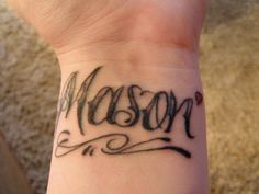 a wrist tattoo with the word mason on it