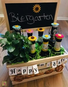 a wooden crate filled with beer bottles and flowers next to a sign that says happy birthday