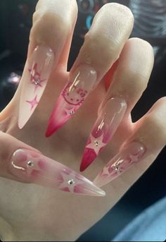 a hand with pink and white nail designs on it