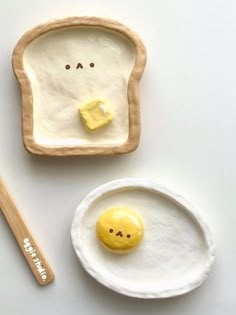 an egg in a toasted bread bowl with a smiley face painted on the side