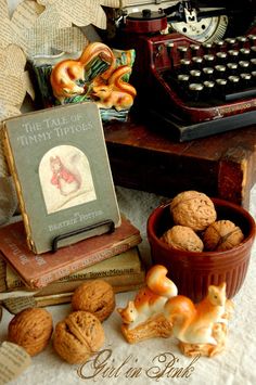 an old typewriter, some nuts and other items are sitting on a table next to each other