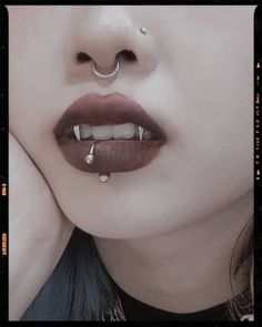 a woman with piercings on her nose