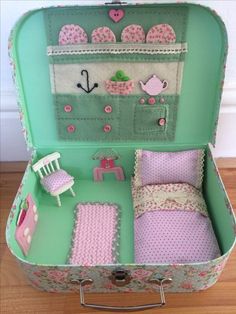 an open suitcase with pink and green decor