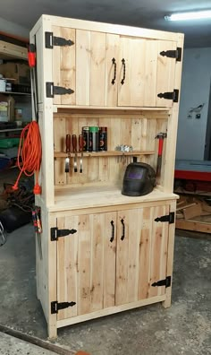 a wooden cabinet sitting inside of a garage