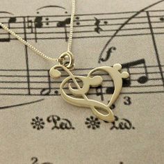 a musical note with a treble in the shape of a heart on top of sheet music