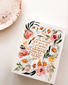 a card with flowers on it next to a plate