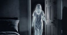 a ghostly woman walking into a bedroom through an open door with the light shining on her