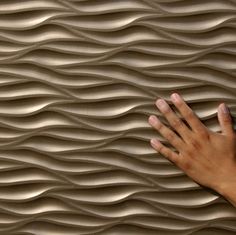 a person's hand on top of a wavy surface