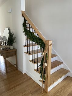 there is a christmas garland on the bannister next to the stair case in this house