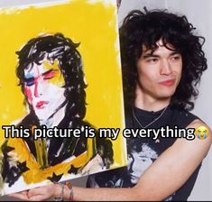 a man holding up a painting with the caption'this picture is my everything '