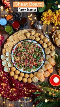 a platter filled with different types of food on top of a wooden table next to candles