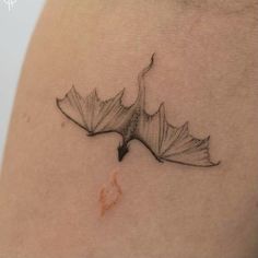 a black and white photo of a leaf tattoo