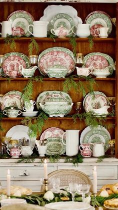 a china cabinet filled with dishes and candles