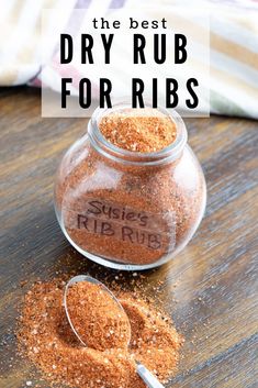 a jar filled with dry rubs on top of a wooden table