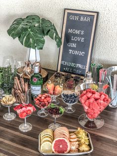 a wooden table topped with lots of different types of food and drinks on top of it