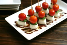 small appetizers with tomatoes and mozzarella drizzled in chocolate