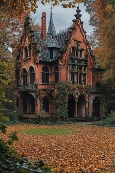 an old house with ivy growing on it's roof and windows, surrounded by leaves